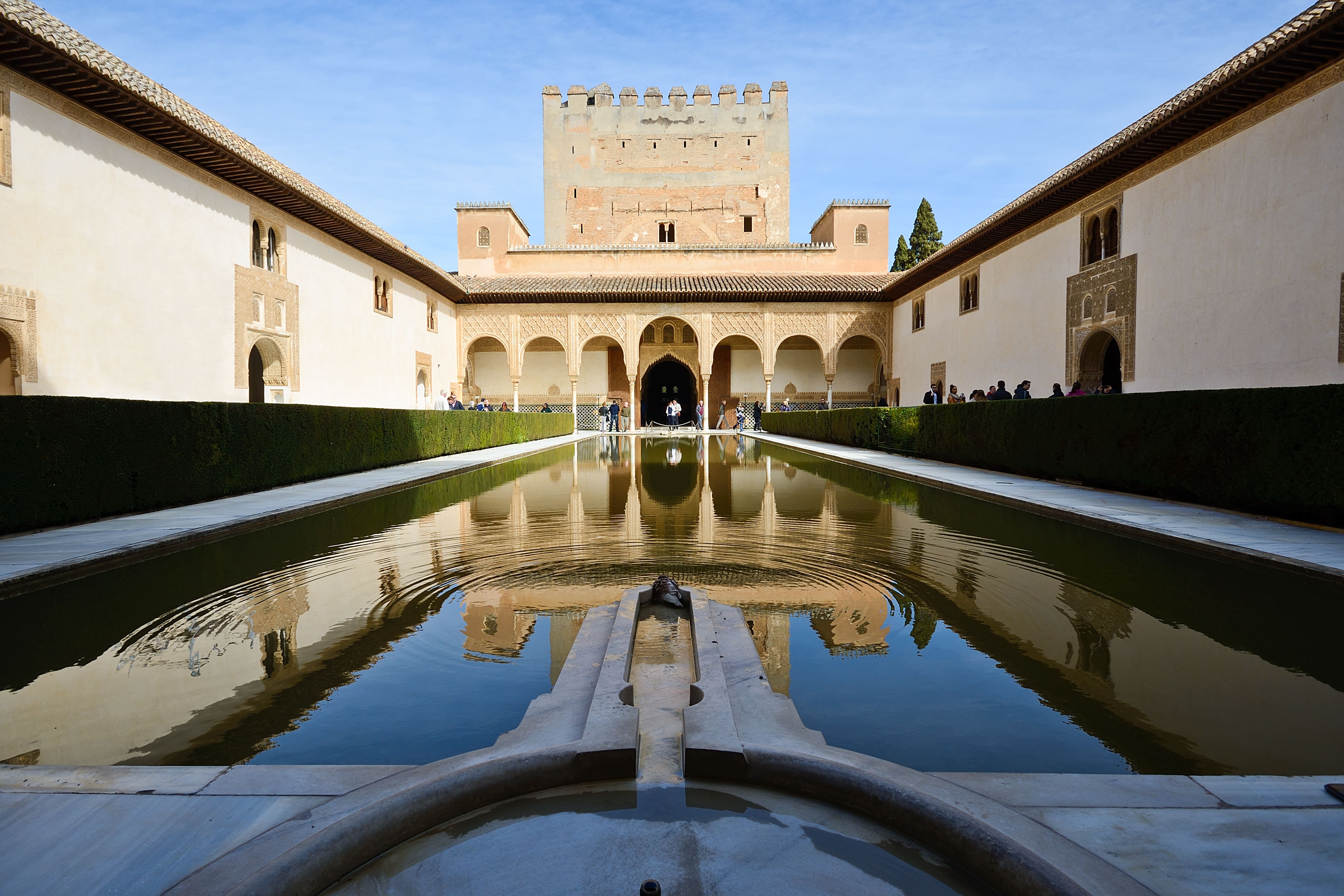 Moorish palace reflecting pool courtyard representing Marrakech luxury real estate