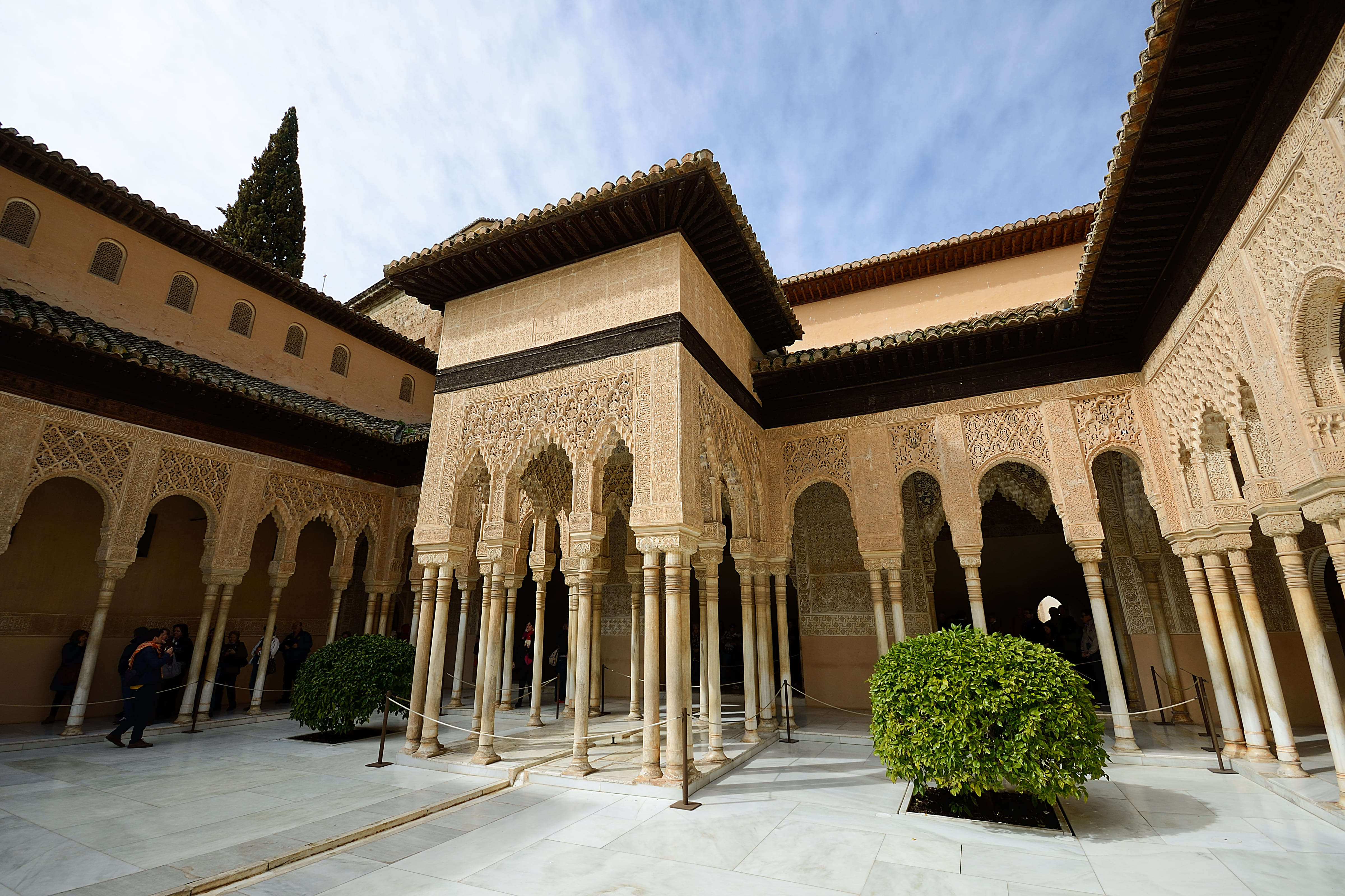 Moorish riad courtyard with arched columns and intricate plasterwork in Marrakech